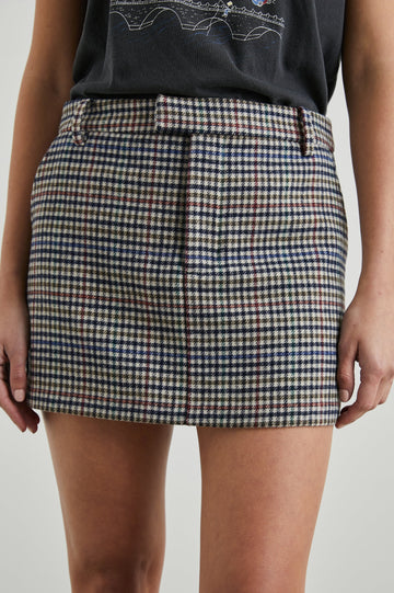 Prim Mini Skirt with Hidden Closure, Belt Loops, Two Front Pockets and Two Back Welt Pockets in Cardinal Pine Multi Colorway, a Plain in Cardinal, Pine, Navy and White - Front View Featured on Model 