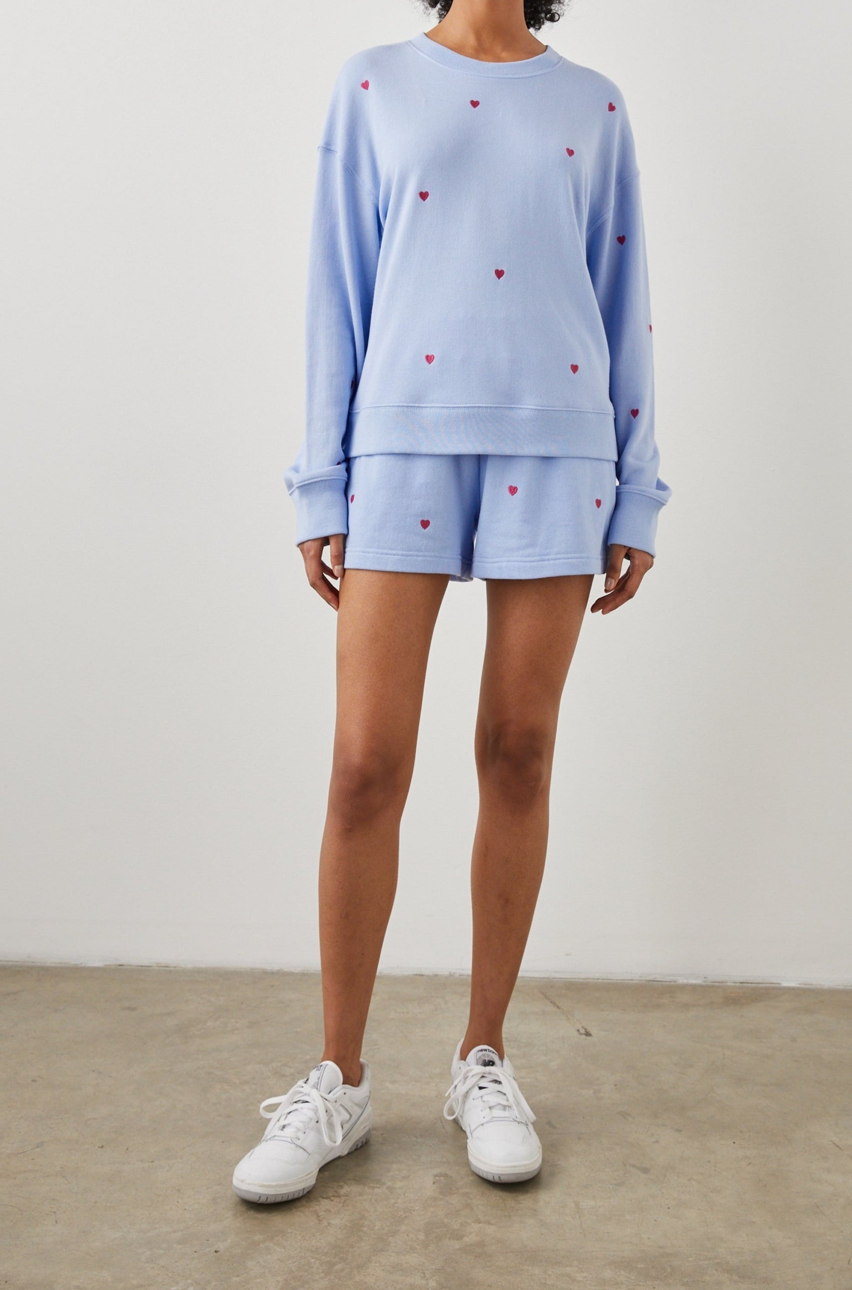 Ramona Long-Sleeve Sweatshirt with a Crew Neck in Pink Heart Embroidery Colorway, Pink Hearts on Blue - Front Full Body View Featured on Model