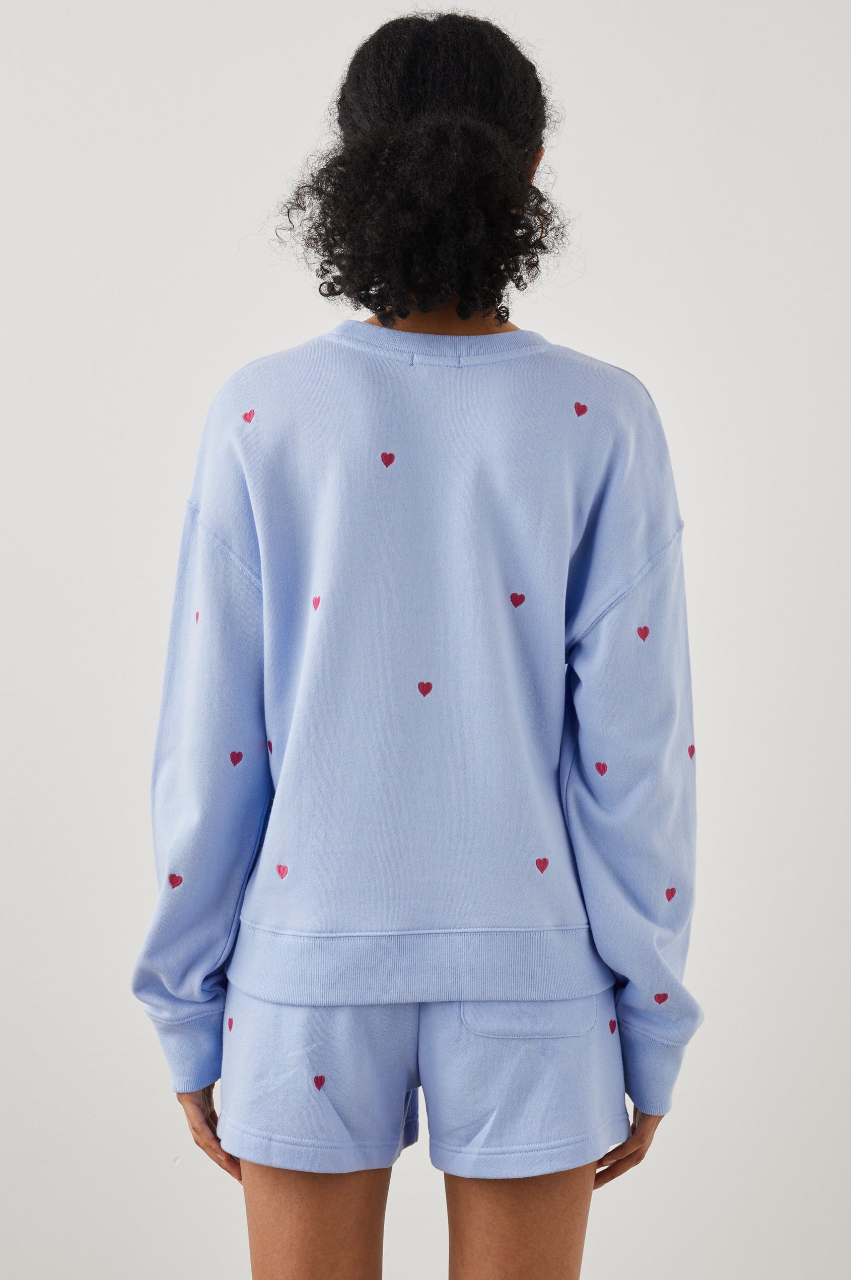 Ramona Long-Sleeve Sweatshirt with a Crew Neck in Pink Heart Embroidery Colorway, Pink Hearts on Blue - Back View Featured on Model