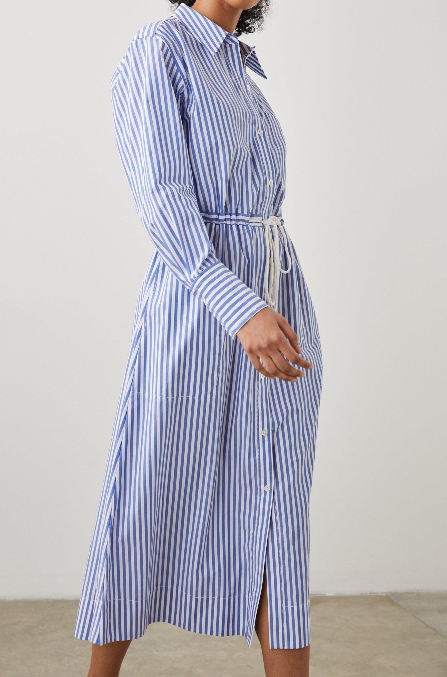 Shivonne Long-Sleeve Midi Dress with a Full Button Front, a Collar and a Drawcord Waist in Rivera Stripe Colorway, Blue and White Vertical Stripes - Side Full Body View Featured on Model