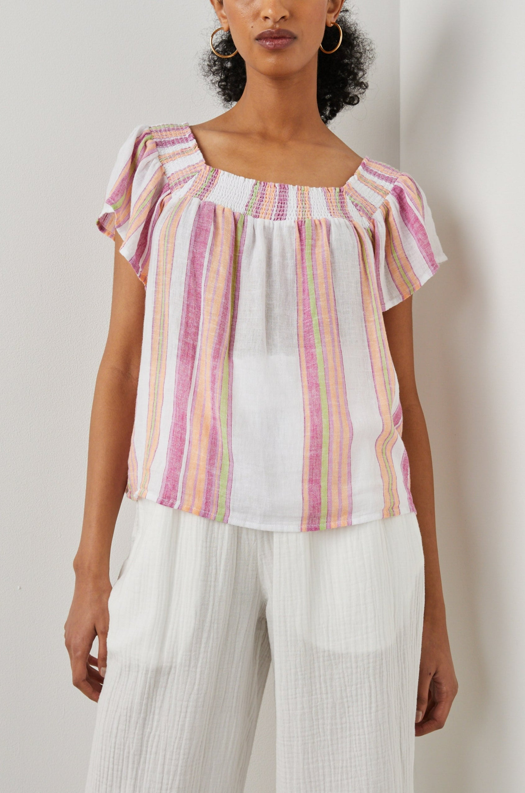 Sonora Short Sleeve Top with a Scoop Neckline and Shirring at the Neckline in Hibiscus Stripe Colorway, Vertical Stripes in Green, Orange, Pink and White - Front View Featured on Model 