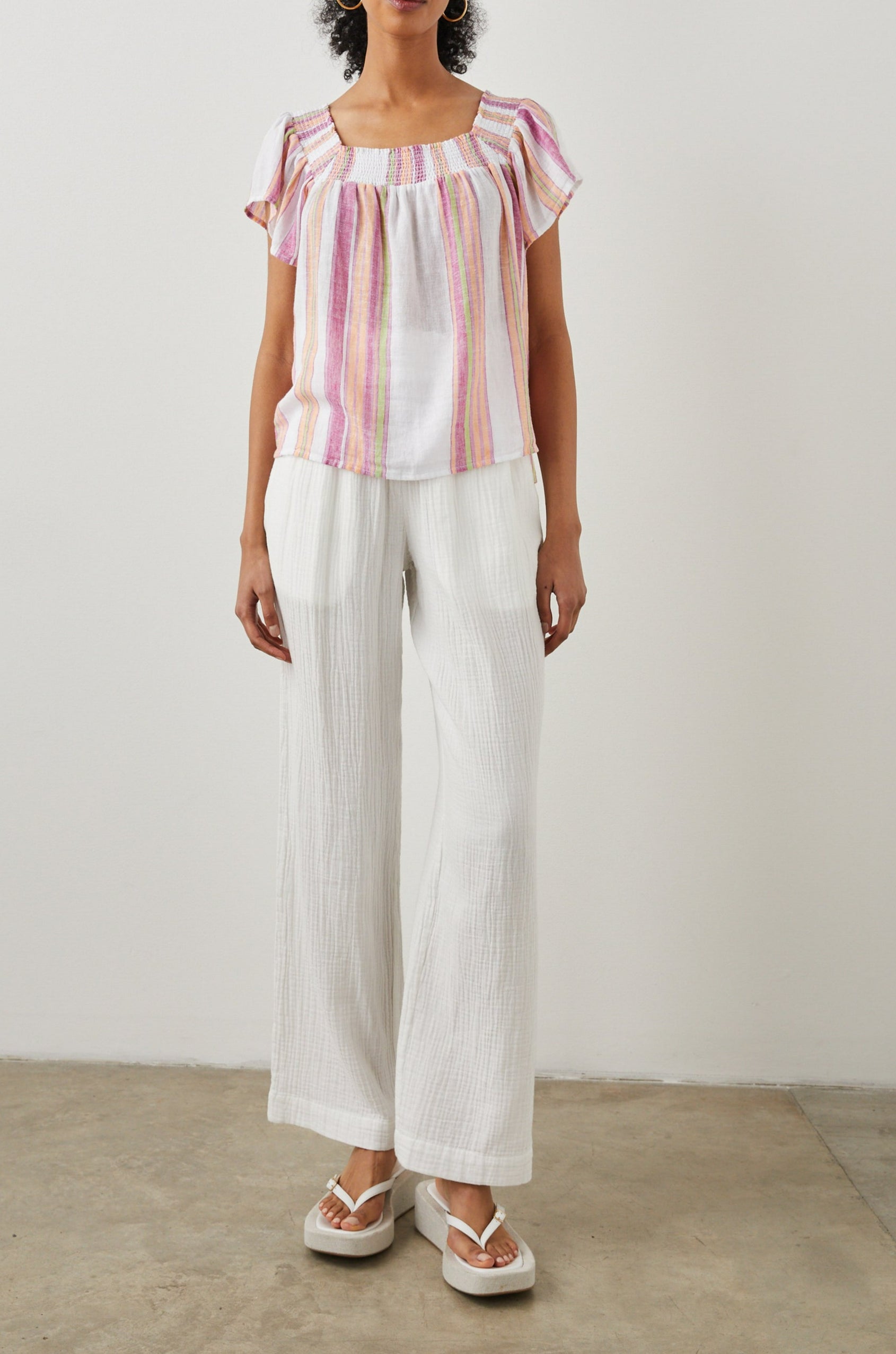 Sonora Short Sleeve Top with a Scoop Neckline and Shirring at the Neckline in Hibiscus Stripe Colorway, Vertical Stripes in Green, Orange, Pink and White - Front Full Body View Featured on Model 