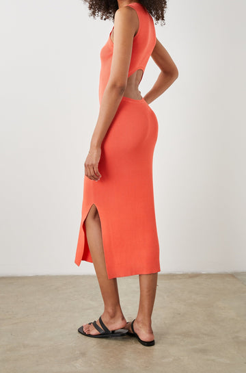 Syd Ribbed, Sleeveless Midi Dress with Wide Shoulder Straps, a Side Slit, and a Cutout that Spans the Lower Back in Black Colorway - Side Full Body View Featured on Model  