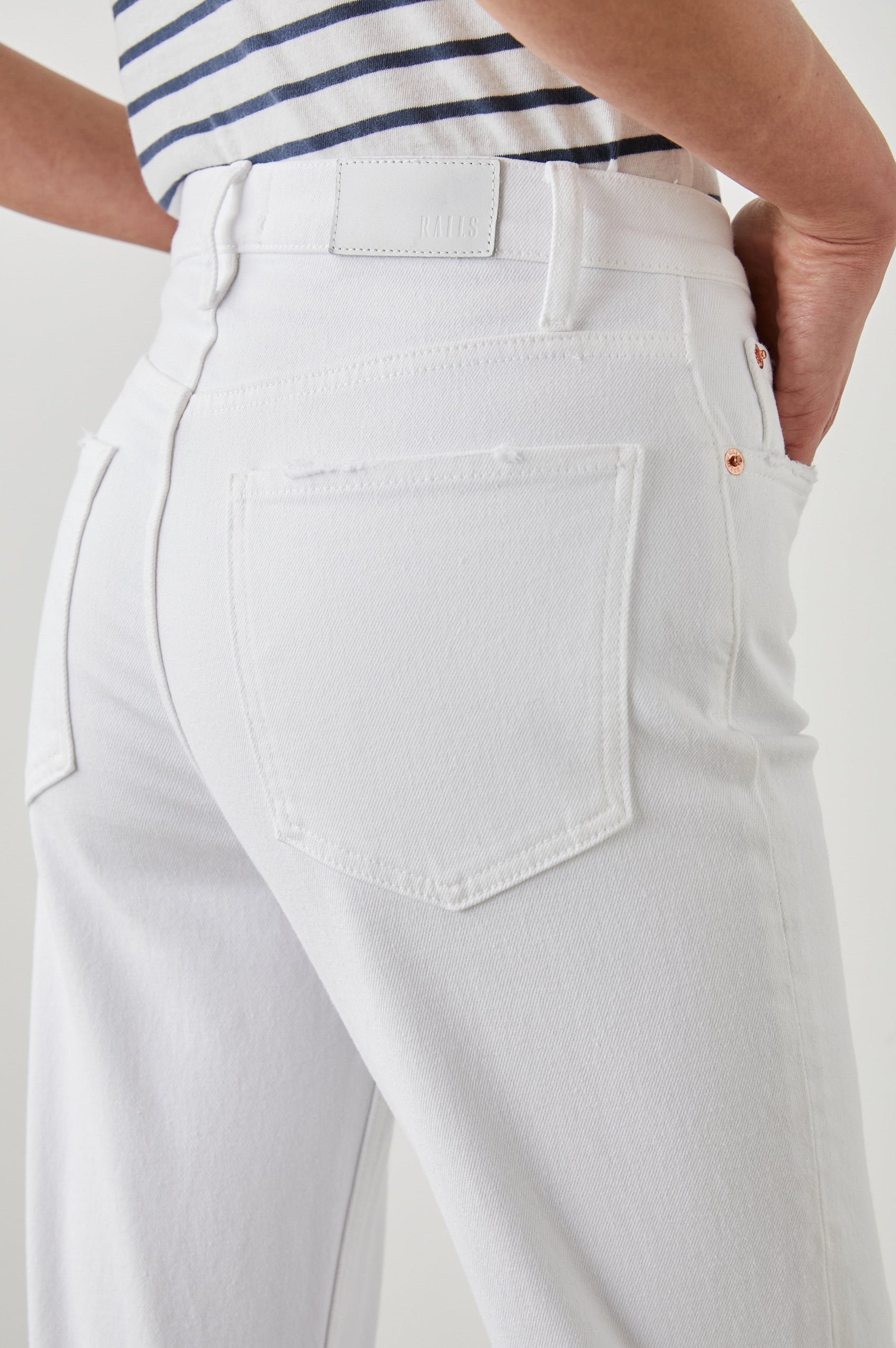 Topanga Straight Jeans with a Hole at the Knee and Fraying, Belt Loops, Two Front Pockets plus a Coin Pocket and Two Back Patch Pockets in Salt White Distress Colorway - Back View Featured on Model
