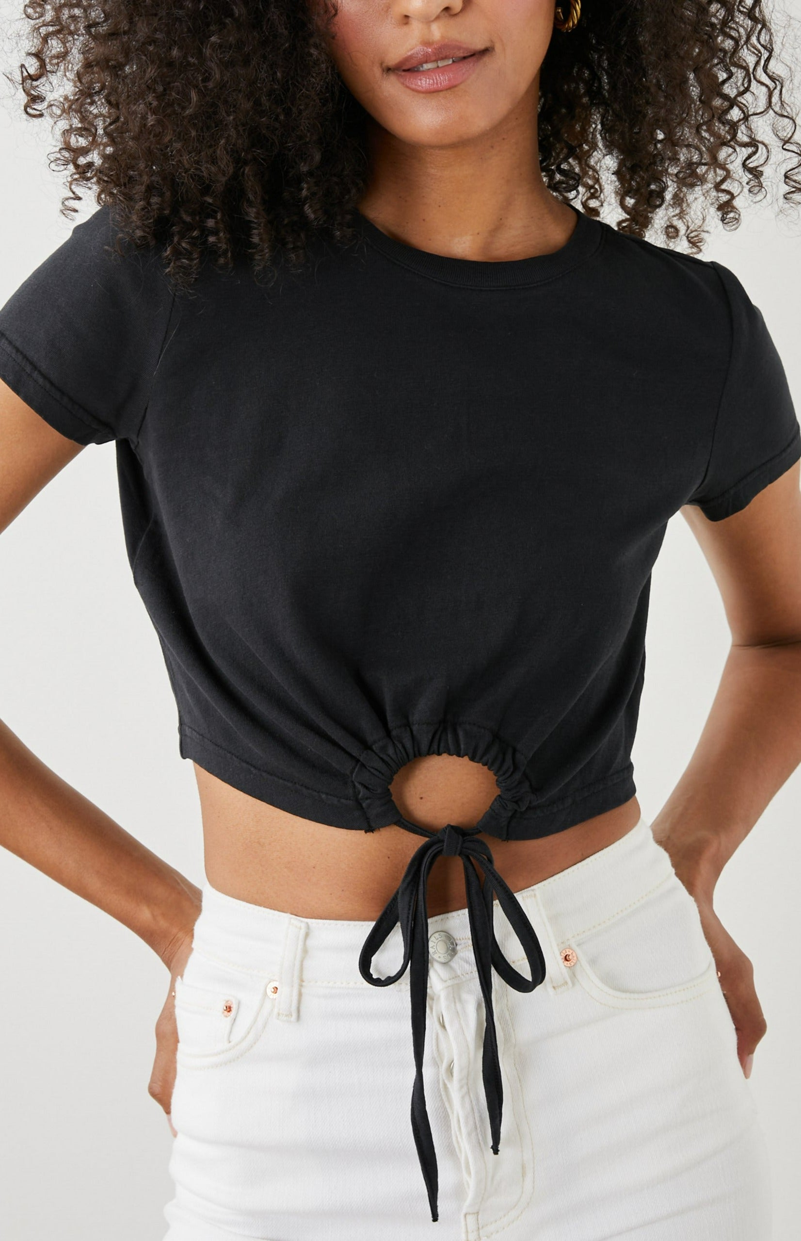 Zena Short-Sleeve Cropped T-Shirt with a Crew Neck and a Circular Cutout with a Tie at the Front Hem in Black Colorway - Front View Featured on Model 