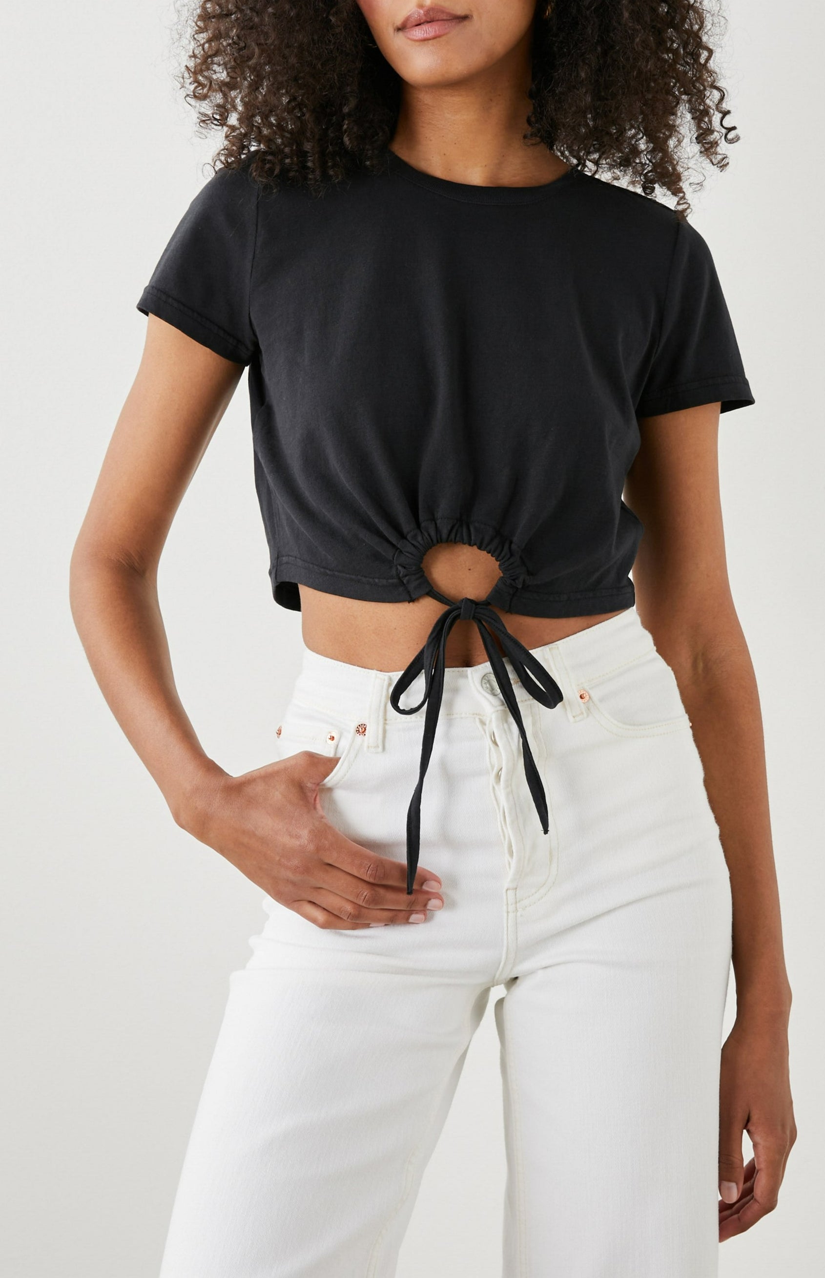 Zena Short-Sleeve Cropped T-Shirt with a Crew Neck and a Circular Cutout with a Tie at the Front Hem in Black Colorway - Front View Featured on Model 